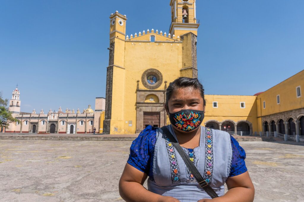 Hispanic female standing at The Convent of San Gabriel Arcangel in Cholula, Mexico