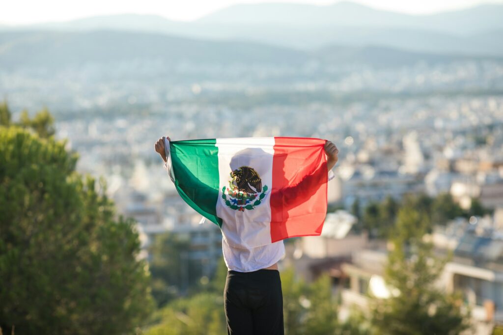 People holding flag of Mexico. "September 16. Independence Day of Mexico.