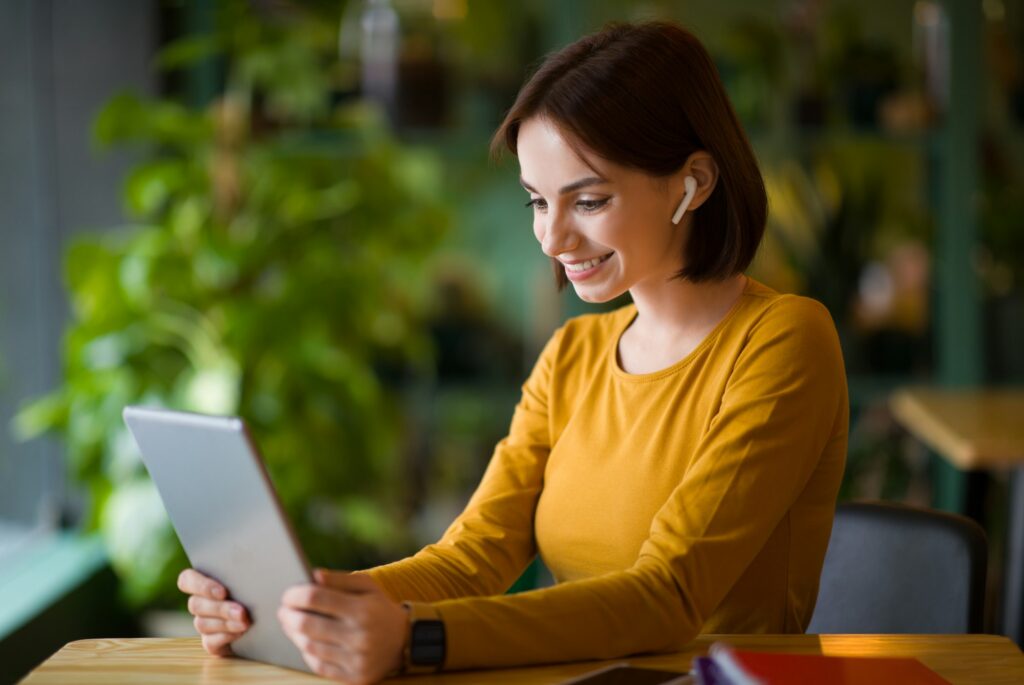 Cheerful attractive young businesswoman having online business meeting